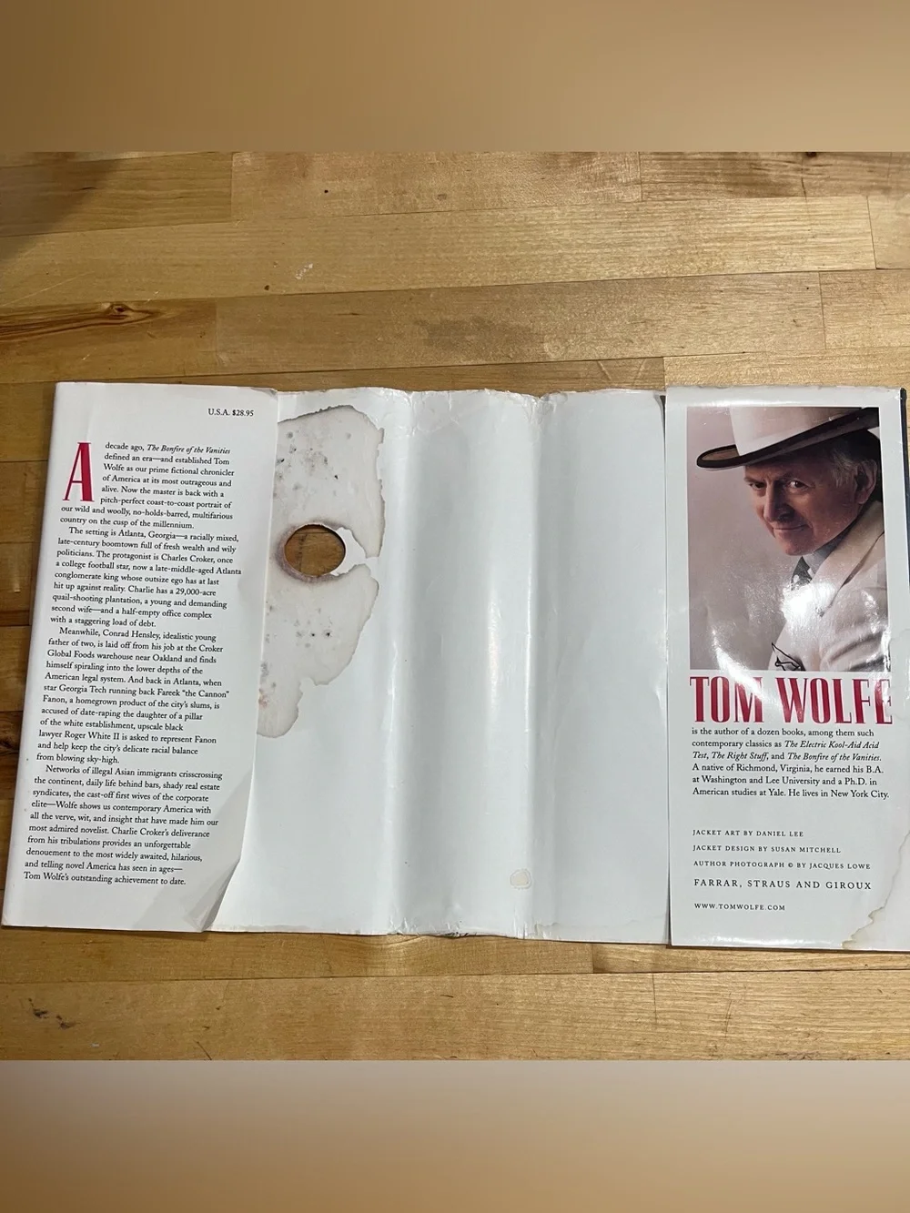 Tom Wolfe FIRST TRADE EDITION HC 1998. Damaged dust cover. Good Spine.